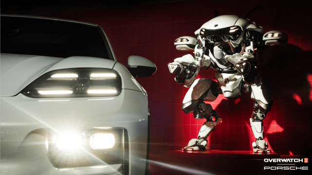 Un Porsche Macan et une statue du mech Porsche de D.Va à côté.