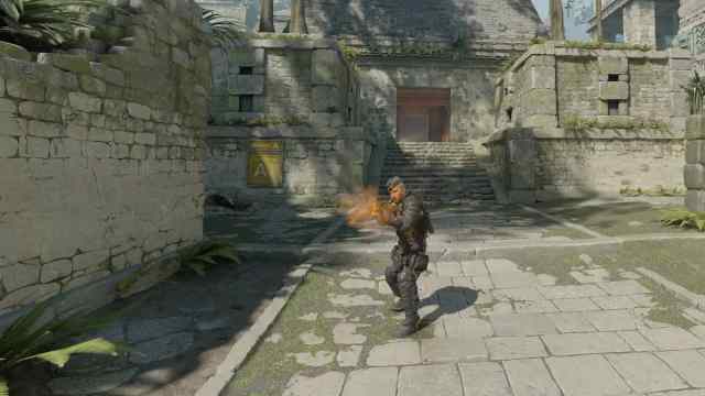 Un personnage de CS2 tirant son arme.