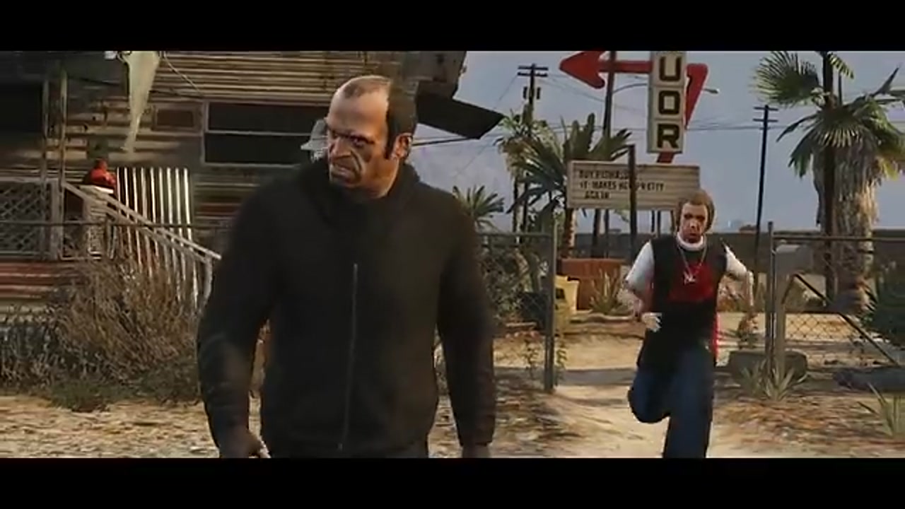 Scène du trailer Grand Theft Auto V : un homme en pull noir marche devant un motel 